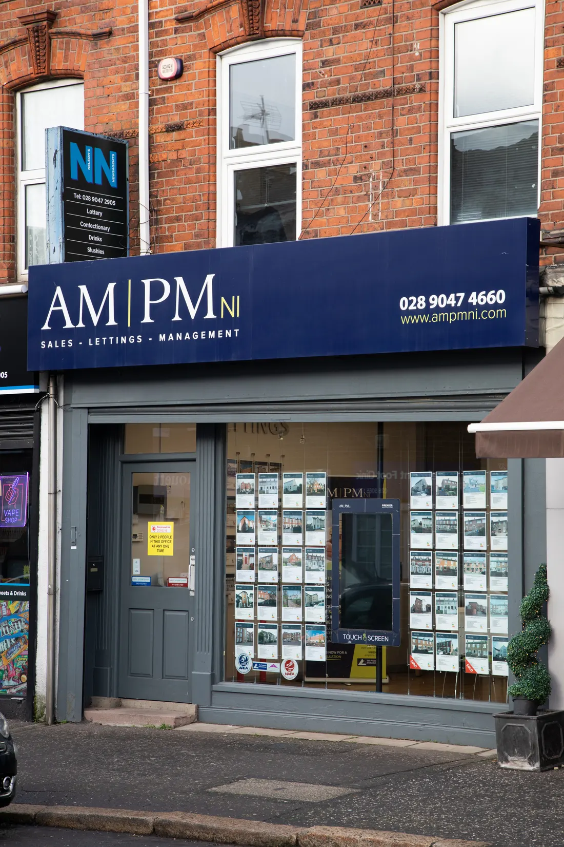 AM PM estate agency illuminated shop front signage